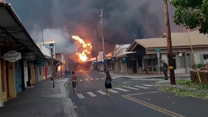 Smoke and flames fill the air from raging wildfires on Front Street in downtown Lahaina, Maui. Photo / Alan Dickar via AP
