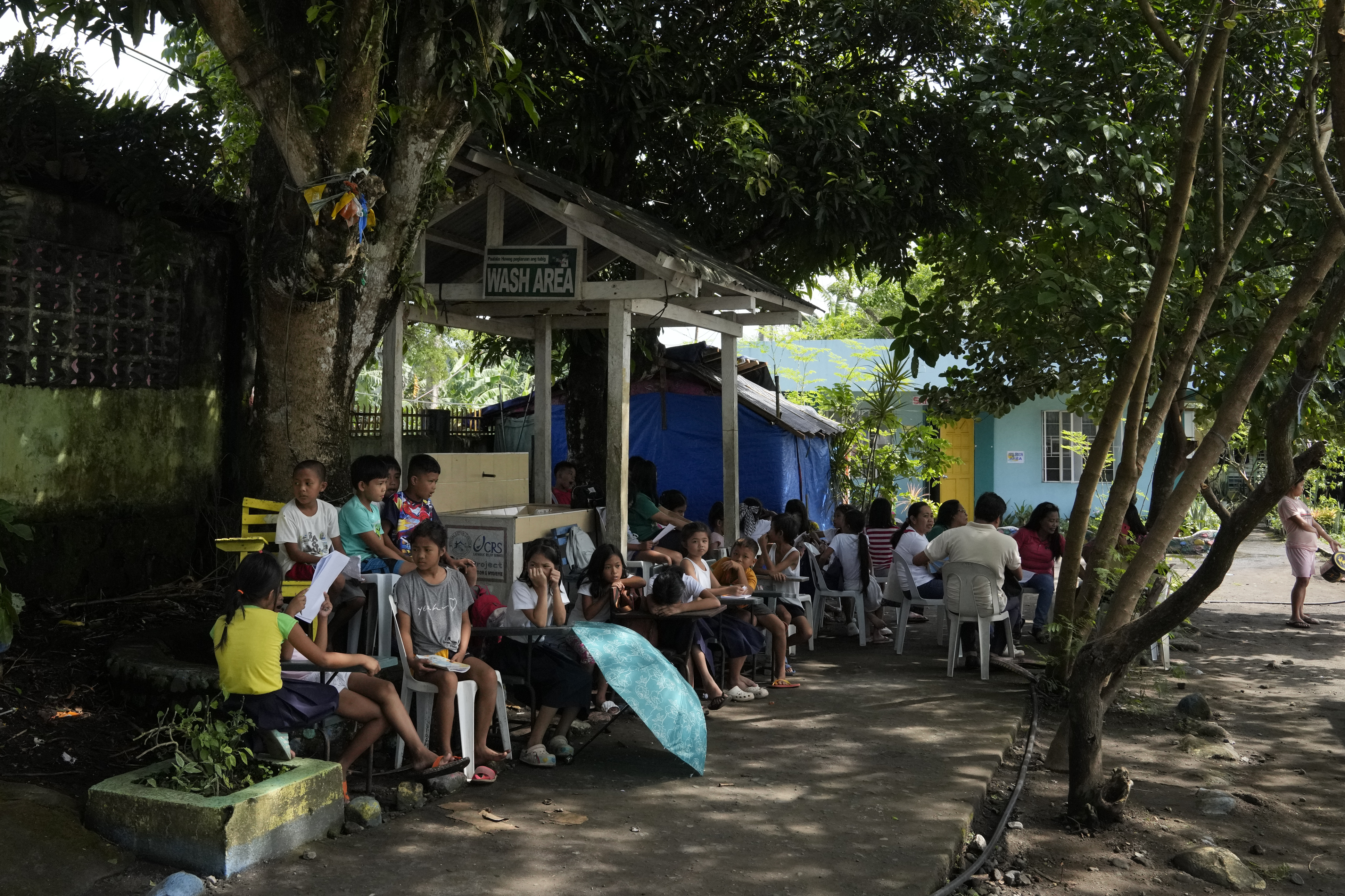 Students hold class under trees as the school was converted into a temporary evacuation center at Malilipot town, Albay province, northeastern Philippines, Thursday, June 15, 2023. Photo / AP