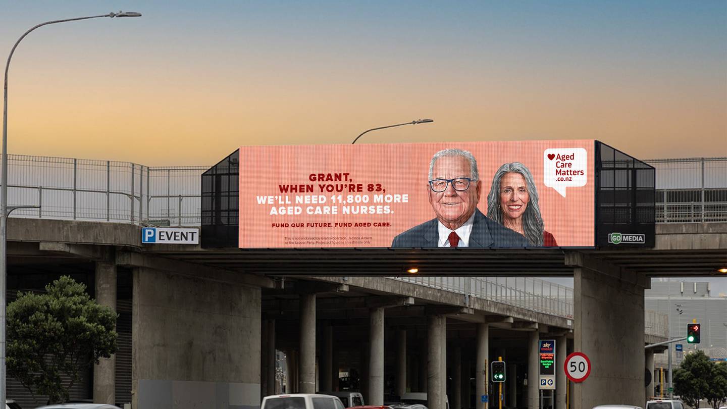 A billboard showing an aged Grant Robertson and Jacinda Ardern.