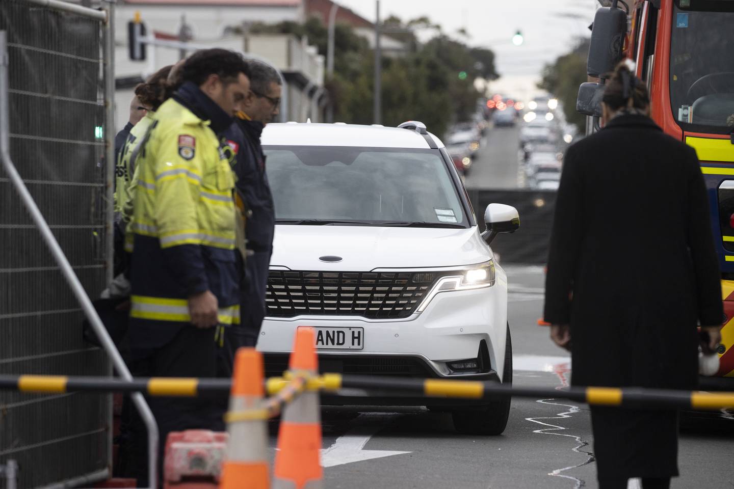 Emergency services formed a guard of honour along a footpath near the hostel when the first body was removed from the scene. Photo / George Heard