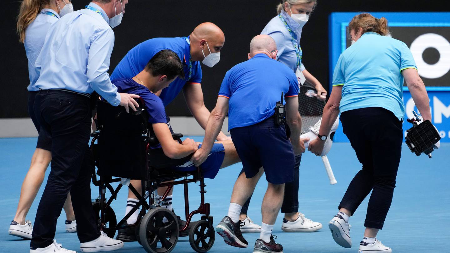 Jakub Mensik of the Czech Republic is taken from the court in a wheelchair following his loss to Bruno Kazuhara of the U.S. in the boys' singles final. Photo / AP