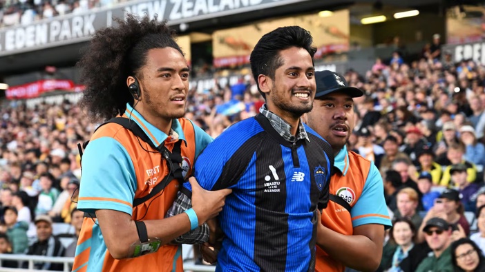 Security removes a pitch invader in an Auckland FC shirt during the Wellington Phoenix v Sydney FC match. Photo / Photosport