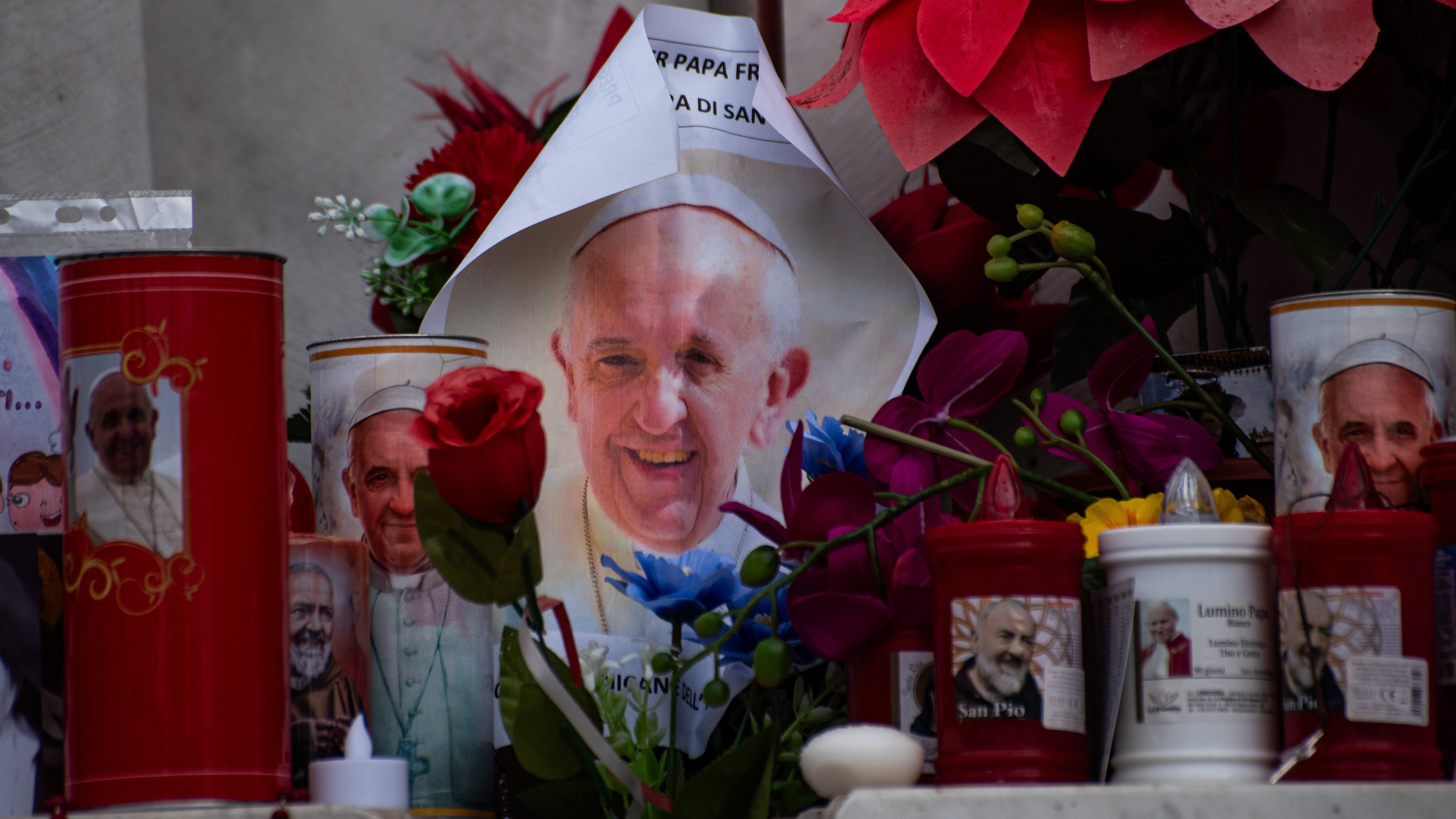 Tributes of flowers, images, candles, and drawings under the statue of Pope John Paul II outside Gemelli Polyclinic in Rome, where Pope Francis has been hospitalized since February 14, 2025. (Photo by Vincenzo Nuzzolese/SOPA Images/LightRocket via Getty Images)