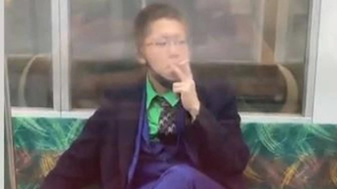 A man dressed as The Joker stabbed several people on a Tokyo commuter train before starting a fire. He then sat down to smoke a cigarette.