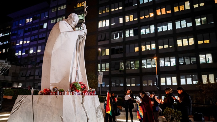 A group of faithful from Bolivia prays for Pope Francis outside the Agostino Gemelli Polyclinic, where he is hospitalized for bronchitis treatment. (Photo by Stefano Costantino/SOPA Images/LightRocket via Getty Images)