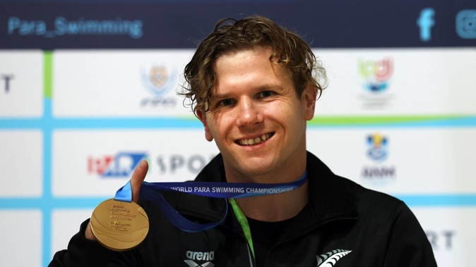 Cameron Leslie with his gold medal from the men's S4 100m freestyle at the World Para Swimming Championships in Portugal. Photo / Supplied