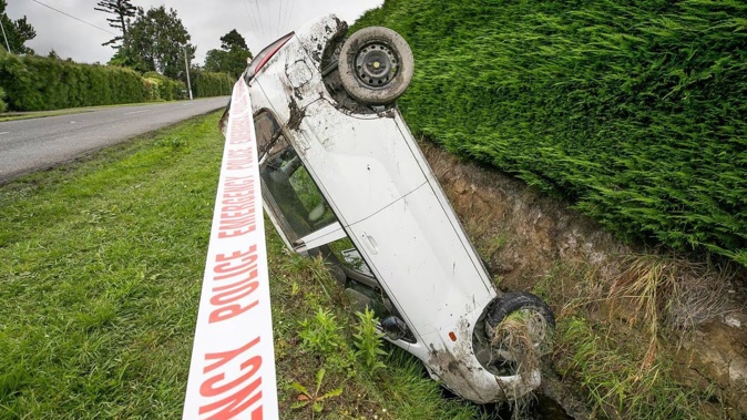 The driver of a car left upside down in the ditch on Riverslea Rd South after an incident on Sunday was issued an infringement by police. Photo / Warren Buckland