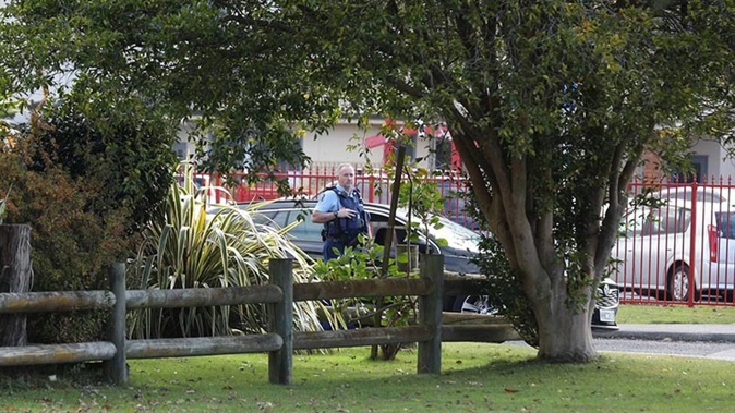 A policeman outside John Paul College. Photo / Andrew Warner