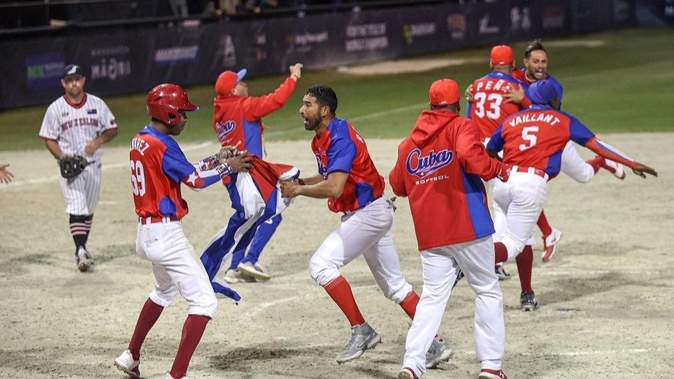 The Cuban team celebrate the tie-break extra inning win over New Zealand. Photo / WBSC