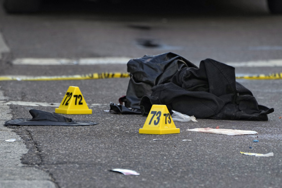 A witch hat, left, and an unidentified object are shown in the street near evidence markers in the Ybor City section of Tampa, Fla., after a shooting, Oct. 29, 2023. Photo / AP