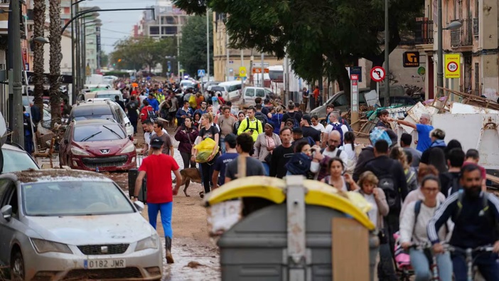 Residents in La Torre, south of Valencia, eastern Spain evacuate after a year's rain fell in a few hours sending torrents of water and mud through towns and cities. Photo / AFP