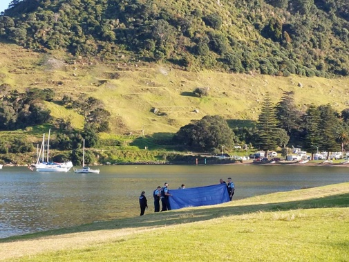 Police at the scene at Pilot Bay where a body has reportedly been found. (Photo / Emma Houpt)