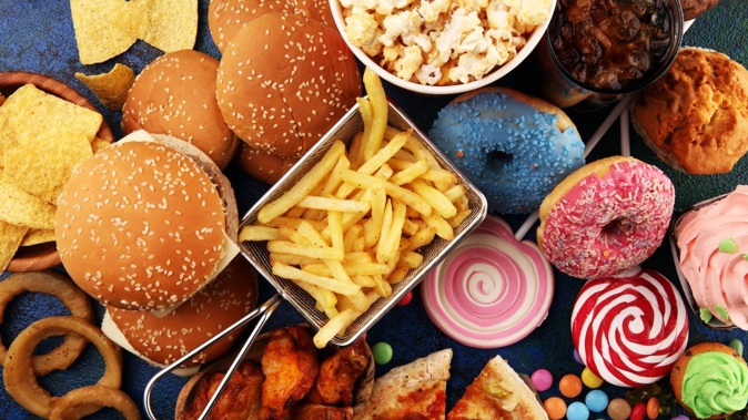 New Zealand should restrict access to junk food instead of blaming people for eating what surrounds them, says a report. Photo / 123rf