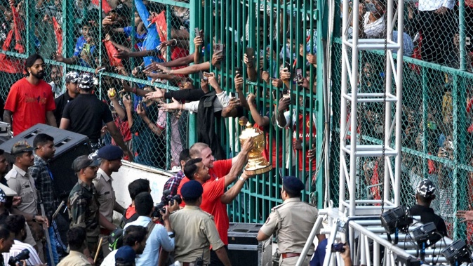 Royal Challengers Bengaluru players carry the Indian Premier League (IPL) trophy during celebrations at the M. Chinnaswamy Stadium in Bengaluru. Photo / AFP