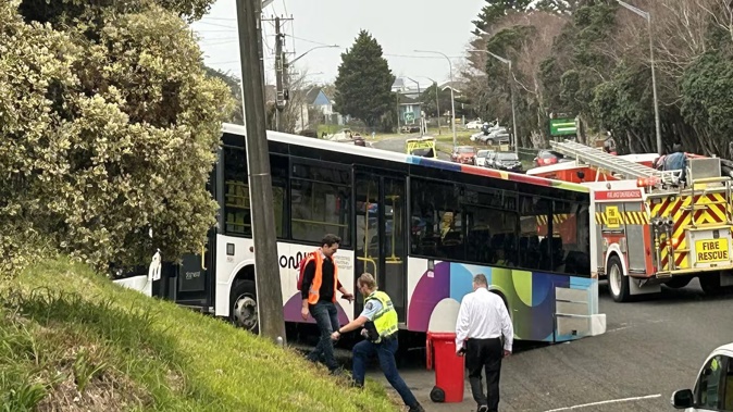 A Whanganui High School bus collided with two cars and rolled up a bank near the school. Photo / Christopher Hirini