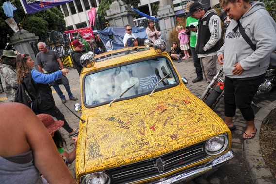 A yellow mini was parked on the Parliament grounds and covered with messages protesters wrote. (Photo / Mike Scott)