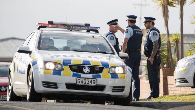 Police officers on Te Atatu Road in West Auckland. Photo / NZME