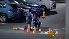 Detectives investigate the serious assault in Manukau, which left two people injured. Photo / Hayden Woodward.