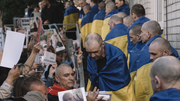 Relatives and military personnel welcome Ukrainian servicemen following a major prisoner of war (POW) swap with Russia at an undisclosed location in Ukraine, on Friday, May 23, 2025. Photographer: Andrew Kravchenko/Bloomberg via Getty Images