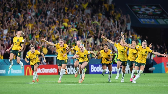 Australia players celebrate after beating France in Brisbane to reach the semifinals. Photo / AP