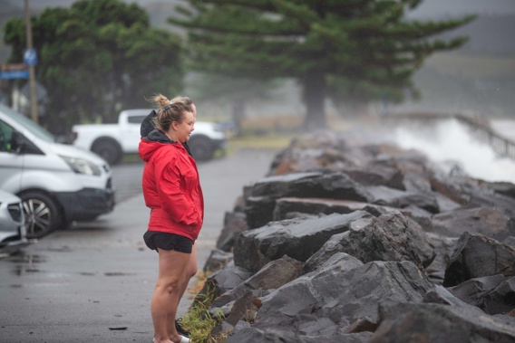 Lisa Black, of Gold Coast, and Nicola Howes of Papamoa watching the storm surge. Photo / Hayden Woodward