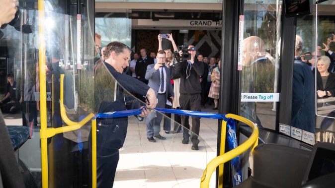 Transport minister Michael Wood cut the ribbon at the launch of a New Zealand made and designed E-bus. Photo / Andrew Warner