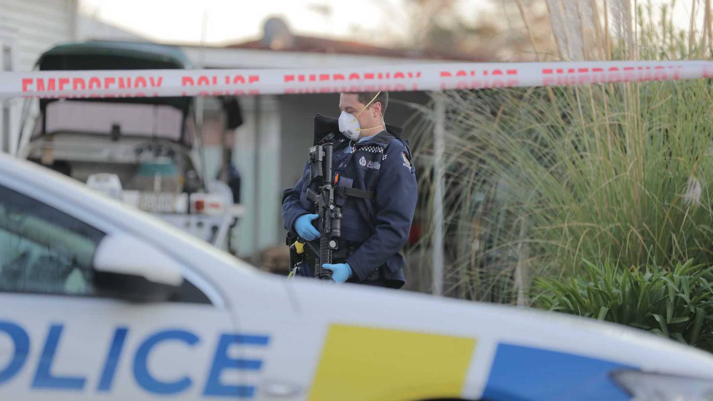 An armed policeman guards the shooting scene in Princes Street East this morning. (Photo / Michael Craig)
