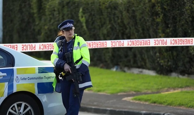 Armed police guard the scene in Beatty St, Ōtāhuhu, on Sunday. (Photo / Hayden Woodward)