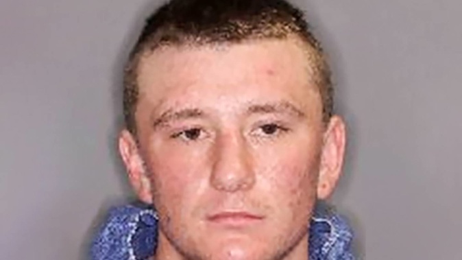 Caine Woodmass, pictured in 2019, now sports a full facial tattoo that includes thick stenciled lettering. Photo / NZ Police