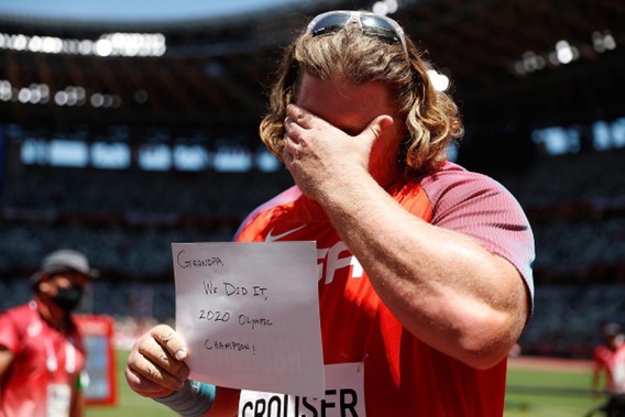 Ryan Crouser of the United States displays a message after winning the men's shot put final. (Photo / Getty)
