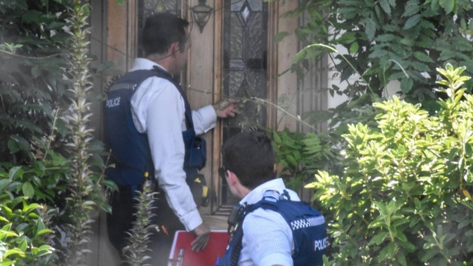 Police arrive at the house of ex-Green MP Golriz Ghahraman yesterday. Photo / George Block