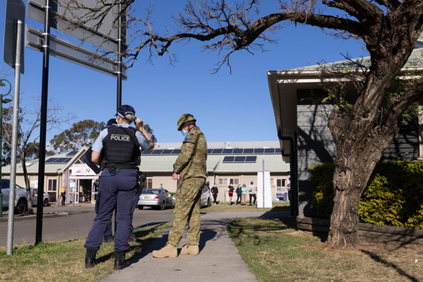 Members of the Australian Defense Force and New South Wales Police are seen outside a pop-up COVID-19 vaccination clinic (Photo/Getty)