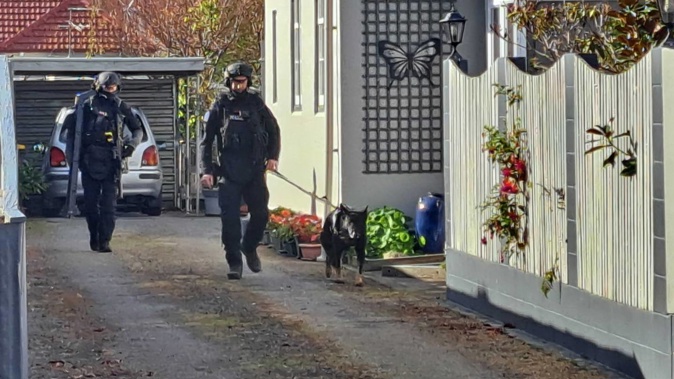 Armed police were seen searching a property on Good St in Rangiora. Photo / Nathan Morton