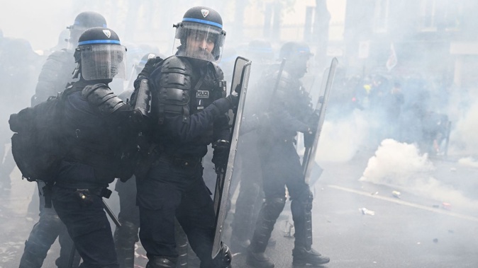Policemen look on during Monday's demonstrations, with fierce clashes between security officials and protesters leading to dozens of arrests. Alain Jocard/AFP/Getty Images