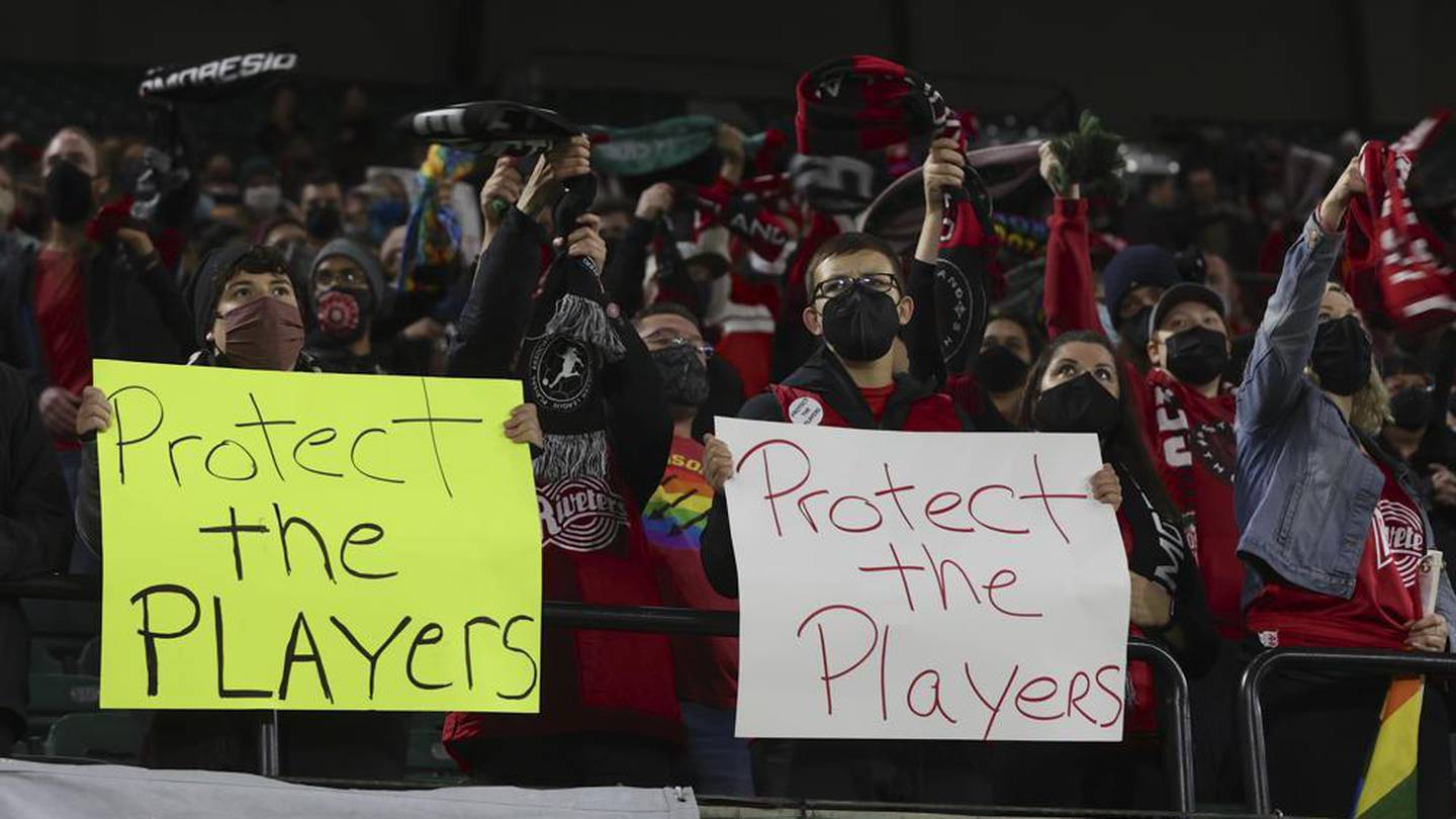 Portland Thorns fans hold signs during the first half of the team's NWSL soccer match against the Houston Dash in Portland, Ore in 2021. Photo / AP