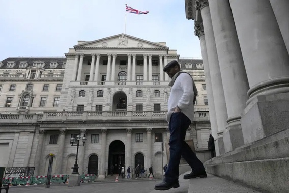 A man walks down steps in front of the Bank of England in London, Thursday, Feb. 2, 2023. The Bank of England is expected to raise interest rates by as much as half a percentage point. That would outpace the latest hike by the U.S. Federal Reserve. The move on Thursday comes as the central bank seeks to tame decades-high inflation that has driven a cost-of-living crisis and predictions of recession. (AP Photo/Frank Augstein)