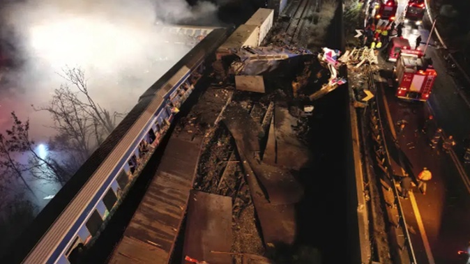 Smoke rises from trains as firefighters and rescuers operate after a collision near Larissa city, Greece. Photo / AP