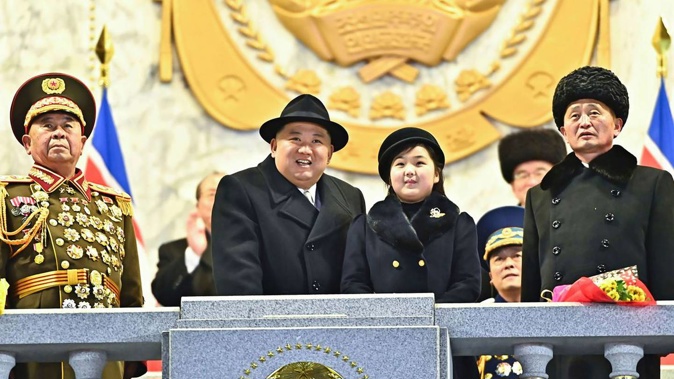 Kim Jong Un with his daughter attends a military parade. Photo / AP