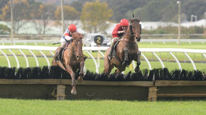 Suliman (right, all red colours) on way to winning Manawatu Hurdle at Trentham. Photo / Supplied