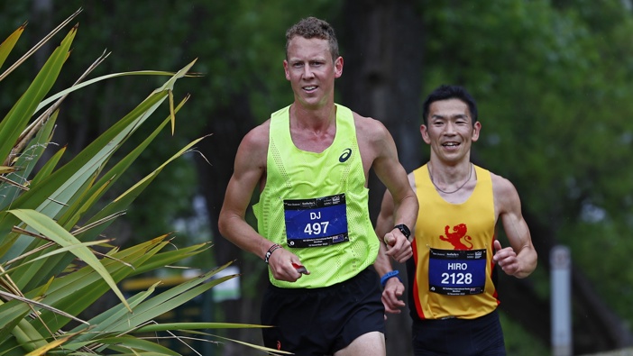 Daniel Jones and Hiro Tanimoto run past Lake Hayes during the Queenstown International Marathon on November 19, 2022. Photo / Getty