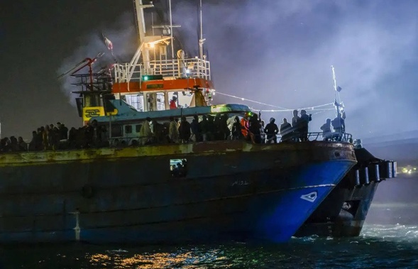 A fishing boat with some 500 migrants enters the southern Italian port of Crotone, early Saturday, March 11, 2023. Italy's right-wing government has declared a state of emergency to help it cope with a surge in migrants arriving on the country's southern shores. Premier Giorgia Meloni and her Cabinet on Tuesday, April 11 decided to impose the emergency status for six months. (AP Photo/Valeria Ferraro, file)
