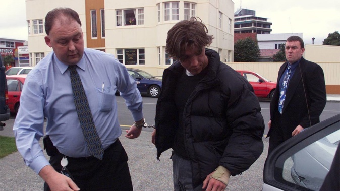 A young William Jan H Haanstra is escorted into Lower Hutt District Court by Detective Kevin Moen (left) and Detective Sergeant Scott Miller. Photo / Mark Mitchell