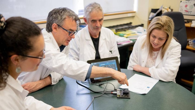 Researchers (from left) University of Otago PhD student Jordon Lima, Professor Mik Black and Professor Parry Guilford with Melissa Vining. Photo / Supplied via Otago Daily Times