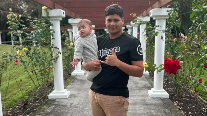 Mukzameel Ali holding 10-month-old Mustafa Ali who police say died a violent death on Saturday.