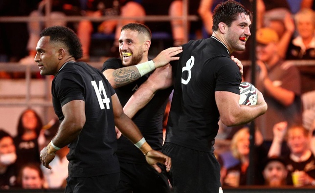 Luke Jacobson (right) is congratulated by teammates TJ Perenara and Sevu Reece after scoring a try. (Photo / AP)