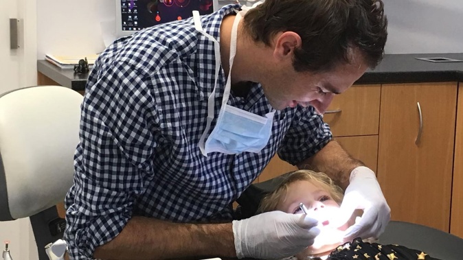Tauranga dentist Dale Benic, pictured with his daughter, says the crash has taken a 'huge toll' on him, his family and his business.