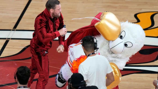 Former MMA fighter Conor McGregor punches Burnie, the Miami Heat mascot, during a break in Game 4 of the basketball NBA Finals against the Denver Nuggets. Photo / AP