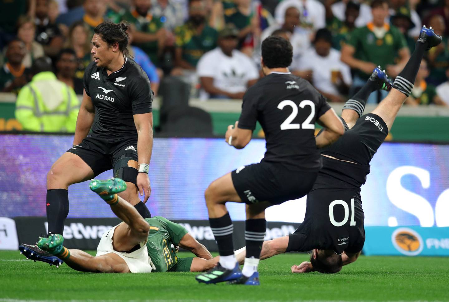 Beauden Barrett is tackled by Kurt Lee Arendse. Photo / Photosport