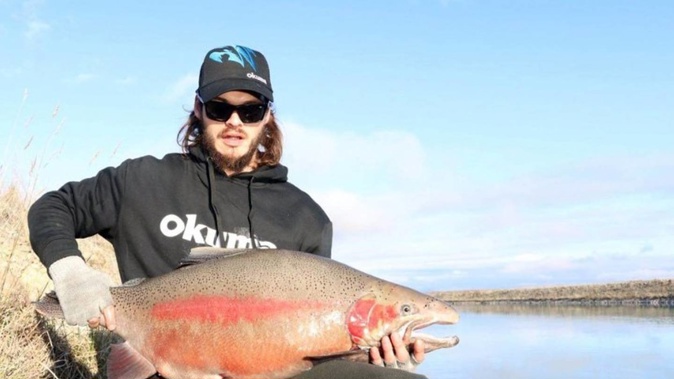 Tyler Byron of Mataura holds the 14.9kg rainbow trout he caught yesterday at the Tekapo Canal. Photo / Supplied
