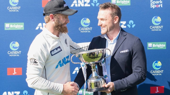 Captain Kane Williamson receives a trophy from former captain Brendon McCullum after the test series win over Pakistan last summer. (Photo / Getty)